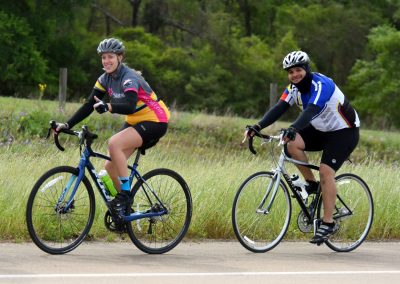 Bike riding with friends on scenic trail in green nature, promoting healthy lifestyle and outdoor adventure.