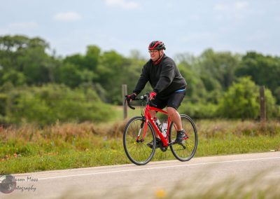 Bright red bicycle on scenic outdoor trail, cyclist enjoying a ride during spring.