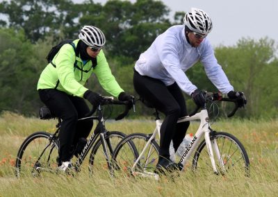 High-performance cycling on the Bluebonnet Express trail with two cyclists in safety gear enjoying outdoor adventure.