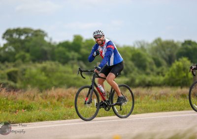 Bright male cyclist smiling on the Bluebonnet Express bike ride in Texas countryside outdoor.