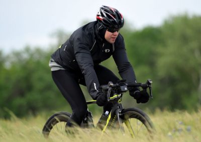 High-performance bluebonnet express cycling bike in outdoor grassy landscape.