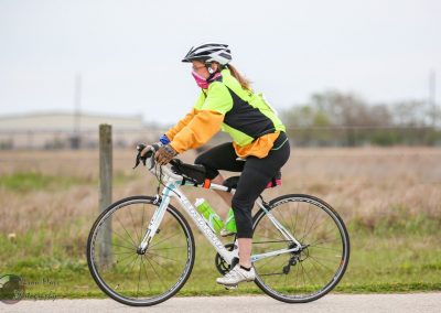 Bright yellow and black cycling jersey with safety gear on Bluebonnet Express bike ride.