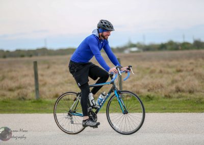 Bright blue-bike racer enjoying outdoor cycling in Texas plains.