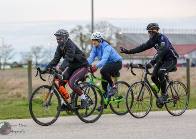 Velo cyclists riding on the trail with face masks and helmets, promoting safe biking with Bluebonnet Express.