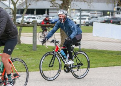 Bright blue bicycle with "Bluebonnet Express" branding in outdoor cycling event, featuring a cyclist in safety gear.
