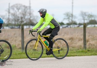 Bright yellow bike on a cycling route during daytime.