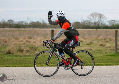 High-performance BMC road bike rider outdoors, promoting Bluebonnet Express cycling event.