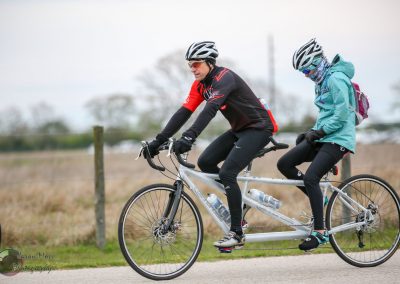 Dual rider tandem bike on scenic outdoor trail, promoting outdoor adventure and family biking fun.
