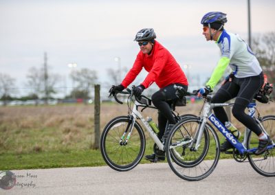 Comfortable cycling ride on Bluebonnet Express trail with two cyclists in colorful gear.
