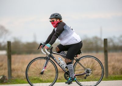 Bright cyclist riding a road bike, promoting Bluebonnet Express cycling event, outdoor, active lifestyle, Texas.