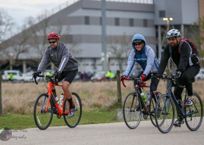 Vibrant cycling group riding on scenic trail in Bluebonnet Express event, showcasing outdoor bike event fun and community engagement.