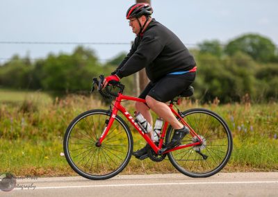 Vegan Man Cycling on Road Bike in Nature.