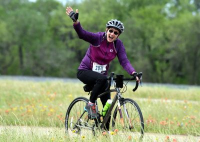 Active woman riding a bicycle through a scenic outdoor trail, enjoying cycling and the fresh air.