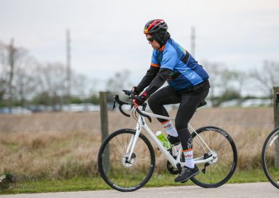 High-performance cyclist riding on the road during a bike race, showcasing endurance and speed.