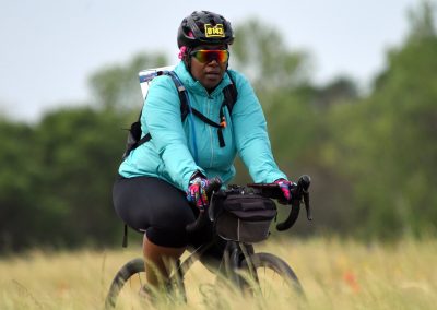 Bike rider wearing a helmet and sunglasses during outdoor biking adventure.