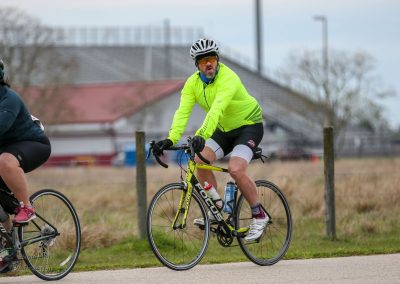 Bright yellow cycling jacket on male cyclist during Bluebonnet Express bike ride event.