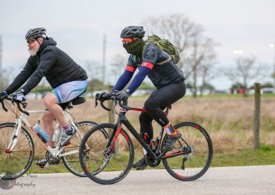 High-performance cyclists riding on outdoor trail, Bluebonnet Express cycling event, athletic biking, outdoor sports, endurance cycling.