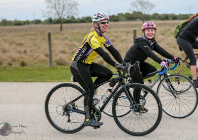 Active women enjoying bike ride on Bluebonnet Express route during outdoor cycling event.