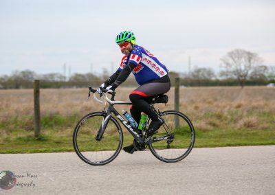 High-performance cyclist riding a road bike in outdoor setting, promoting Bluebonnet Express cycling event.