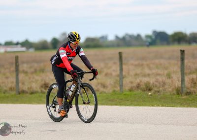 Vivid cyclist riding on a rural course, promoting Bluebonnet Express cycling event and outdoor adventure.