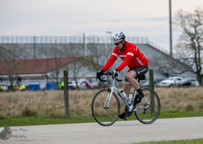 Fast cyclist on the Bluebonnet Express bike route during daytime adventure.