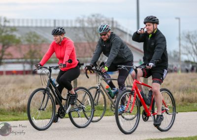 Brightly colored cyclists enjoying a ride on the Bluebonnet Express trail in Texas, promoting outdoor recreation and healthy living.