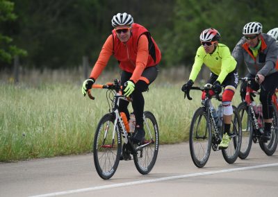 High-performance cyclists riding on a scenic route for Bluebonnet Express bike event.