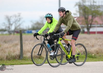 Bright yellow and black Specialized bikes with cyclists enjoying outdoor biking in nature.