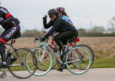 Bright woman cycling on the Bluebonnet Express route, enjoying scenic outdoor riding in texas.