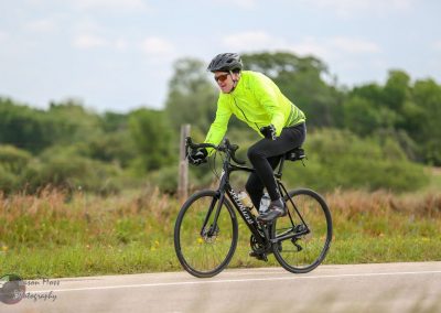 Bright yellow bicycle safety jacket for Bluebonnet Express cycling event.