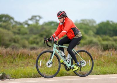 Vibrant cyclist riding a Trek bike on a scenic outdoor trail, embodying adventure and healthy lifestyle.
