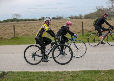 Vibrant cyclists enjoying a scenic ride on Bluebonnet Express bike trail in Texas, showcasing outdoor adventure and cycling fun.