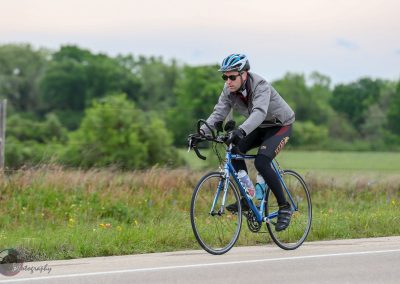 High-quality cyclist on Bluebonnet Express pedal bike in Texas countryside, eco-friendly commuting.