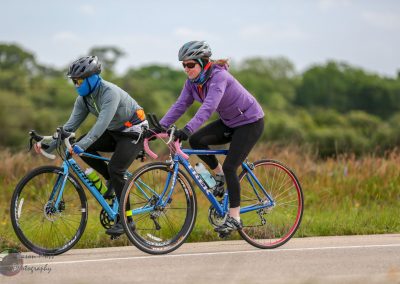 Bike ride with two cyclists on Bluebonnet Express trail in Texas, enjoying scenic outdoor cycling.
