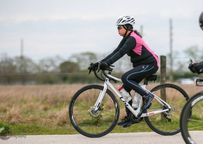 Female cyclist riding a mountain bike outdoors during daytime.