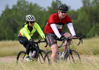 Vibrant cyclists participating in Bluebonnet Express bike race on scenic outdoor trail.