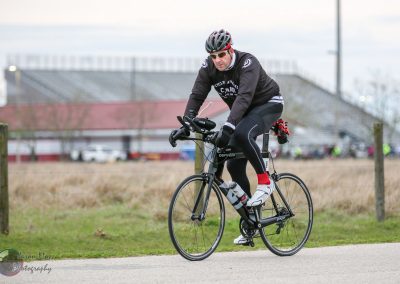 High-performance cyclist riding a Cervélo bike during a racing event or training session outdoors.
