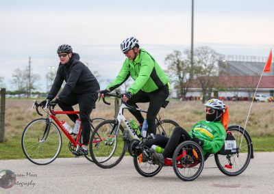 Tour de cyclists with a sidecar electric bike, highlighted by the Bluebonnet Express event, promoting adaptive cycling.