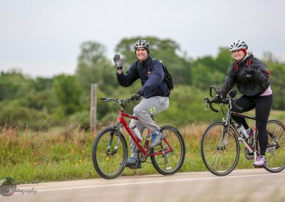 Brightening day with cyclists riding on scenic outdoor trail, enjoying healthy, eco-friendly commutes.
