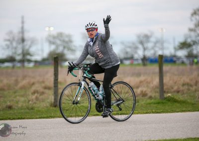 Cyclist riding a bike outdoors, promoting Bluebonnet Express cycling event and Texas cycling community.