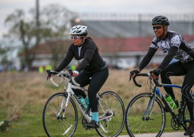 Riders on bikes enjoying a scenic ride at Bluebonnet Express cycling event.