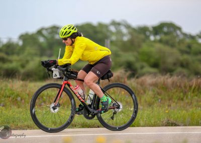 Vibrant cyclist riding on scenic outdoor trail with Bluebonnet Express branding.