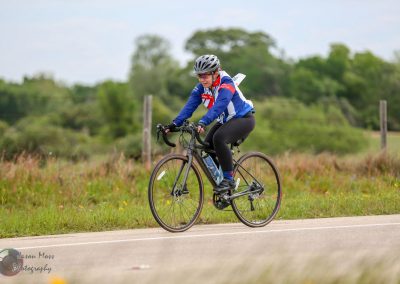 Smooth riding cyclist on scenic rural trail, emphasizing American cycling event and outdoor adventure.