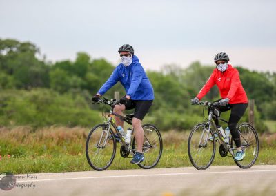 Brightly dressed cyclists on the Bluebonnet Express bike trail for outdoor exercise and scenic rides.