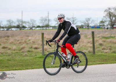 Vibrant cyclist riding a Cervélo road bike on a scenic outdoor trail.