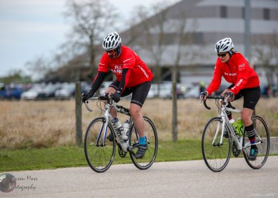 Riders in Red Bluebonnet Express cycling event on a scenic outdoor trail.