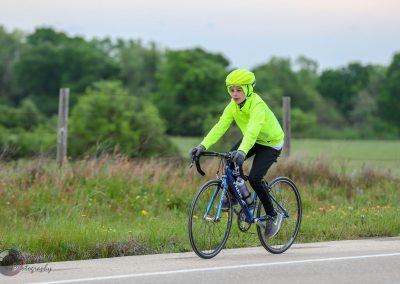 Bright yellow helmet and jacket for safe cycling on country roads.