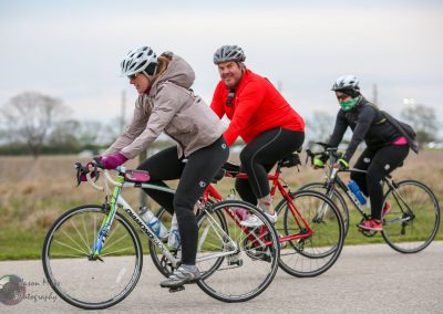 Bright outdoor cycling scene with women and man enjoying Bluebonnet Express bike ride, emphasizing outdoor biking adventure.