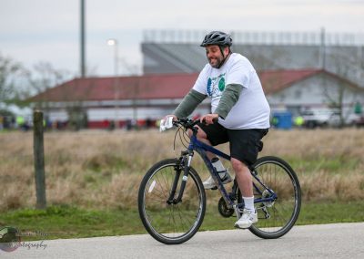 Active man riding a mountain bike during Bluebonnet Express event, promoting cycling and outdoor fitness.