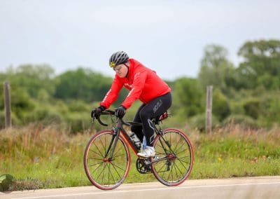 Velo cyclist riding on scenic rural trail, emphasizing outdoor biking adventures.